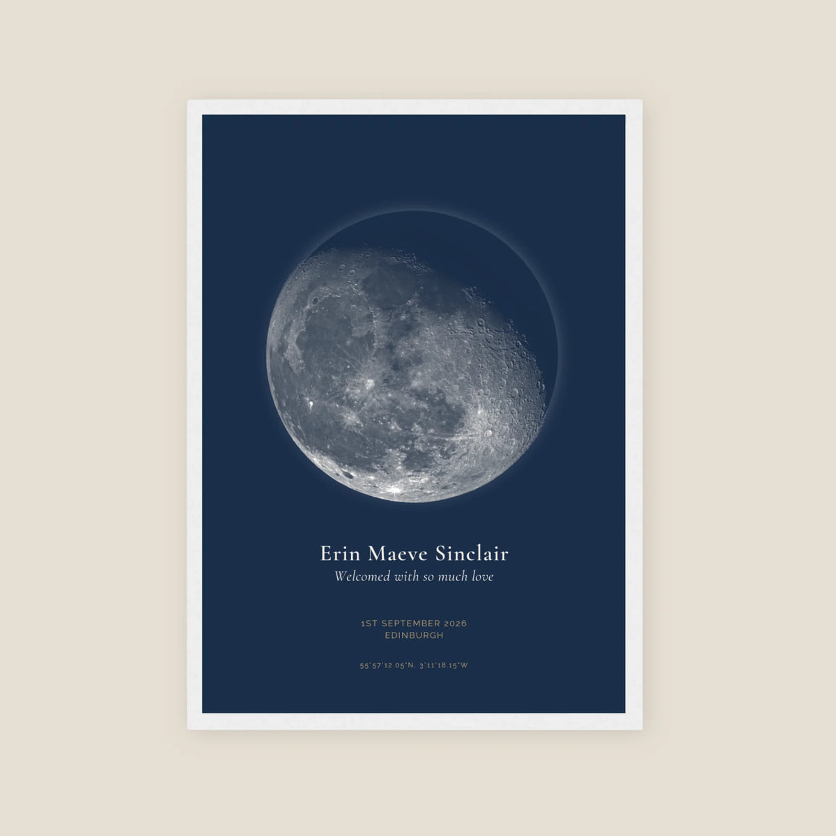 Personalised moon phase print, Jewel, in a white frame, portrait, with a detailed gibbous moon on a deep navy background above a name, date, place and coordinates.