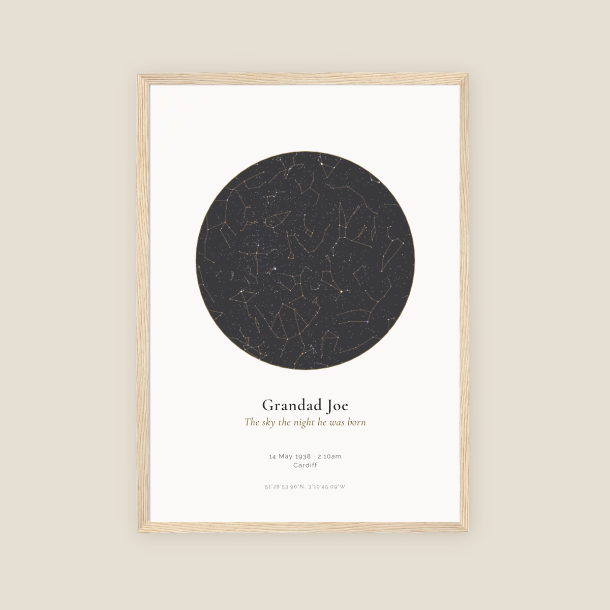Personalised star map print, Jewel, Slate palette, in an oak coloured frame, A3 portrait, showing the night sky over Cardiff with the name Grandad Joe